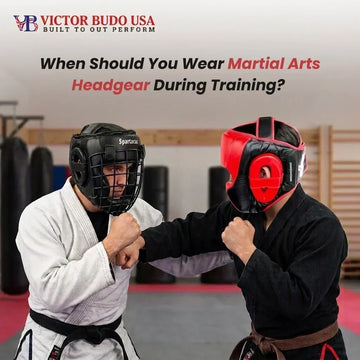 Two martial artists wearing headgear spar in a gym.