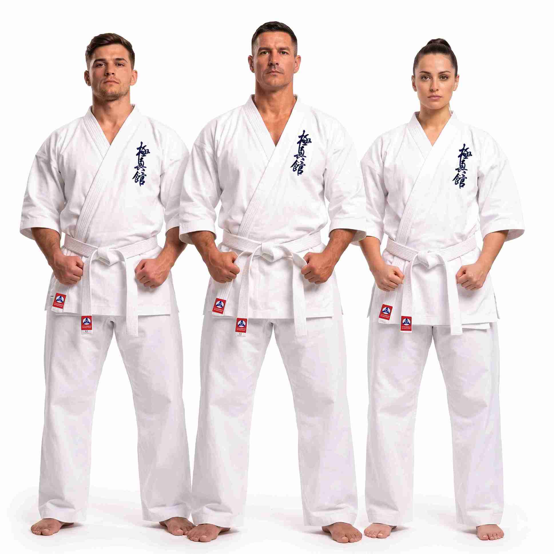 Three martial arts practitioners wearing matching white karate gi uniforms with white belts, standing against a plain white studio background. Each uniform has dark blue Japanese characters on the chest and small red-and-white logo patches near the belt area.