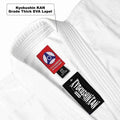 Close-up of a white Kyokushin KAN martial arts gi lapel showing two Kyokushin KAN brand labels, including one red and one black tag, with a text callout reading 'Kyokushin KAN Grade Thick EVA Lapel'.