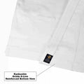Close-up of a white martial arts uniform showing a reinforced hem with a small black Kyokushin label, with a text callout explaining the reinforced bottom hem.