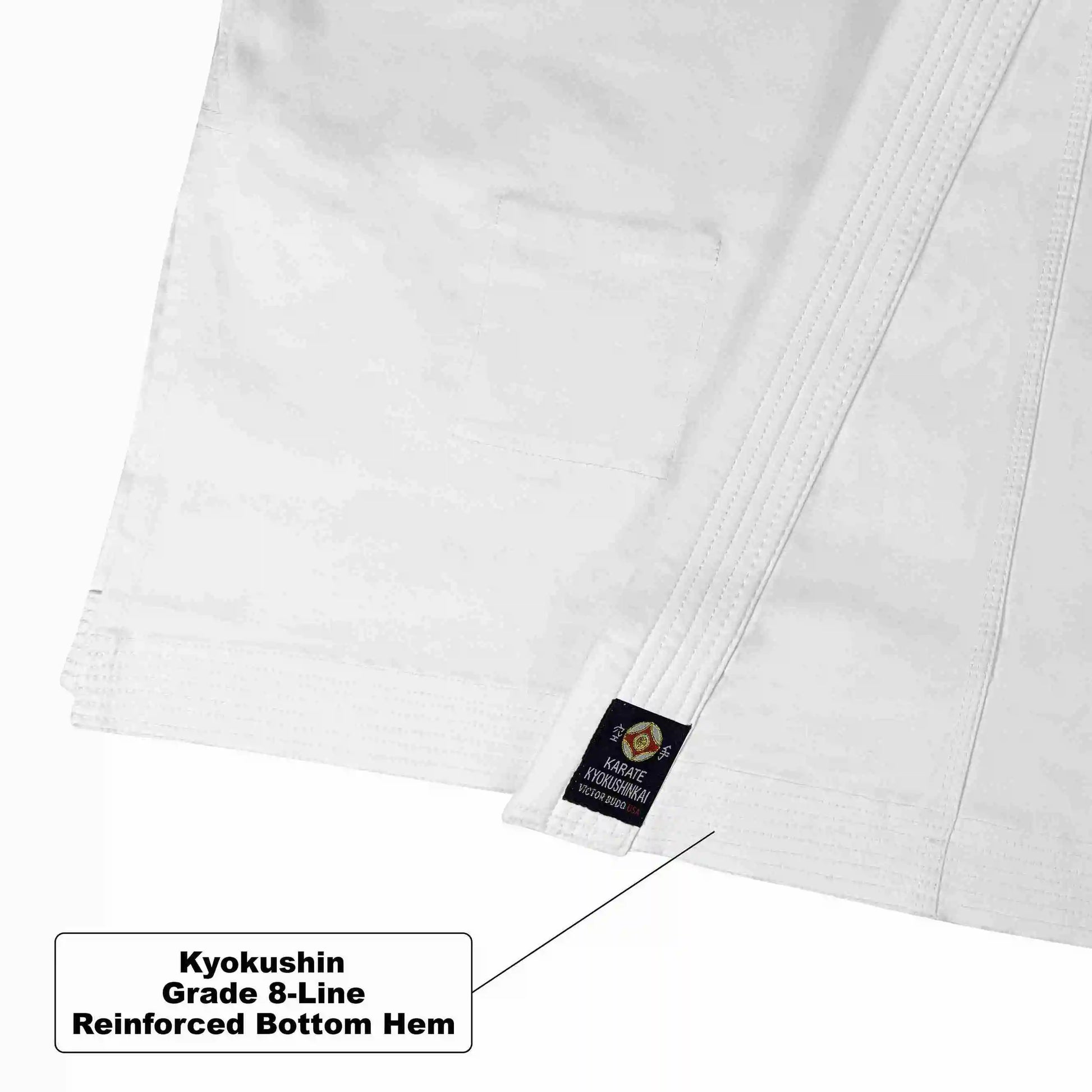 Close-up of a white martial arts uniform showing a reinforced hem with a small black Kyokushin label, with a text callout explaining the reinforced bottom hem.