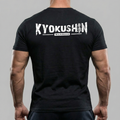 Person wearing a black t-shirt with 'Kyokushin Warrior' text on the back against a gray background