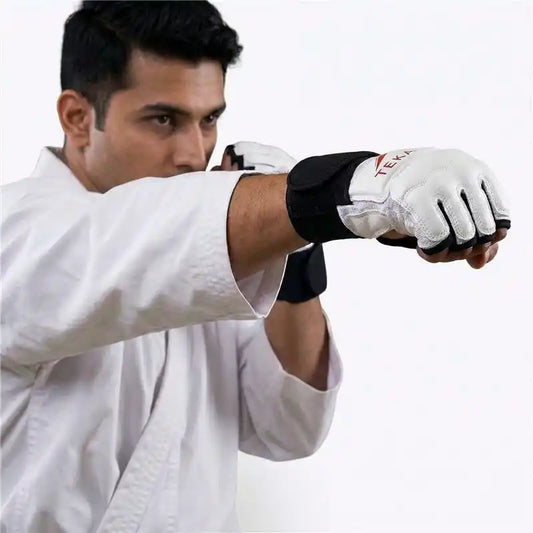 Person in a white martial arts uniform with black and white MMA gloves on a white background