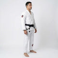 Man wearing a white bjj uniform with a black belt on a white background