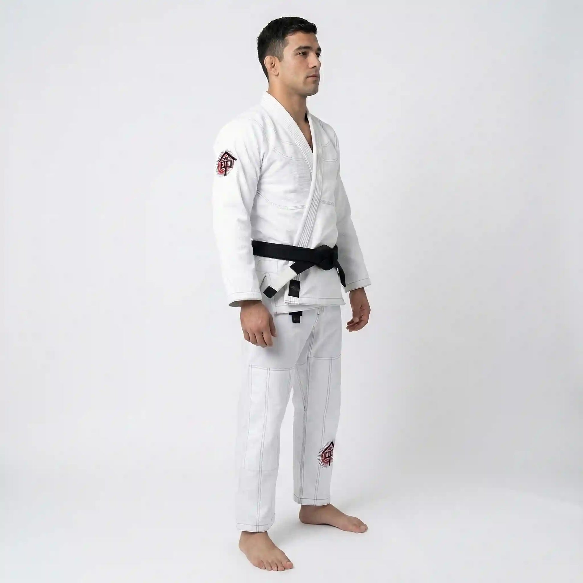 Man wearing a white bjj uniform with a black belt on a white background